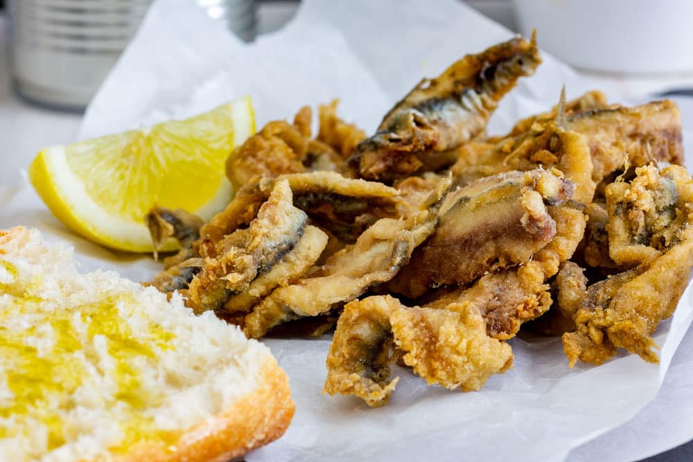 Traditional Spanish tapas fried anchovies with bread and olive oil