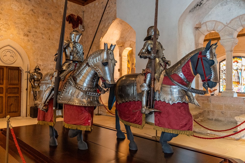 Armored knights on horses at the Alcazar of Segovia