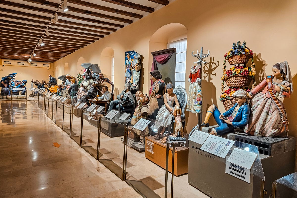 Ninot display at Fallas Museum in Valencia, Spain, showcasing preserved figures from Las Fallas festival.
