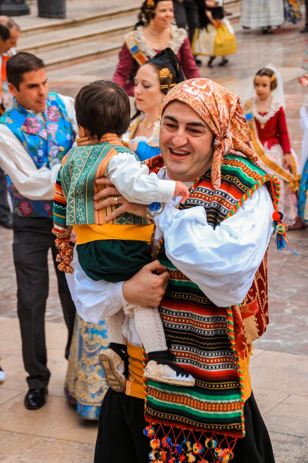 Father carrying his son at the festival