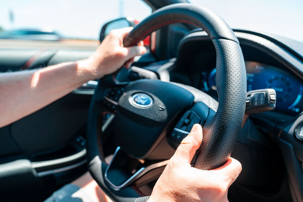 Driver holding steering wheel.