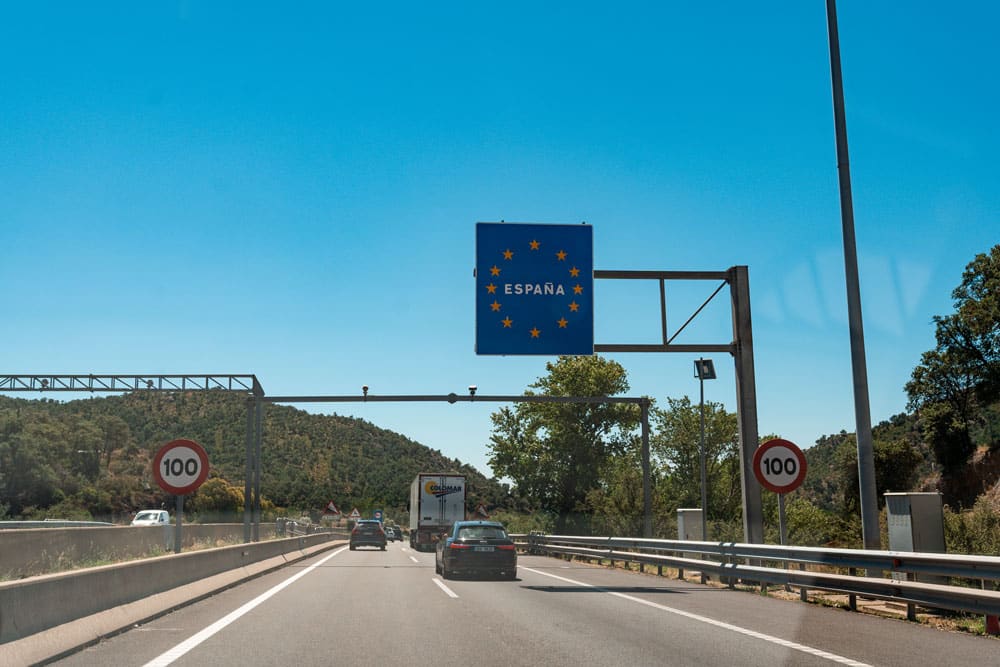 Spain border sign and speed limit signs.