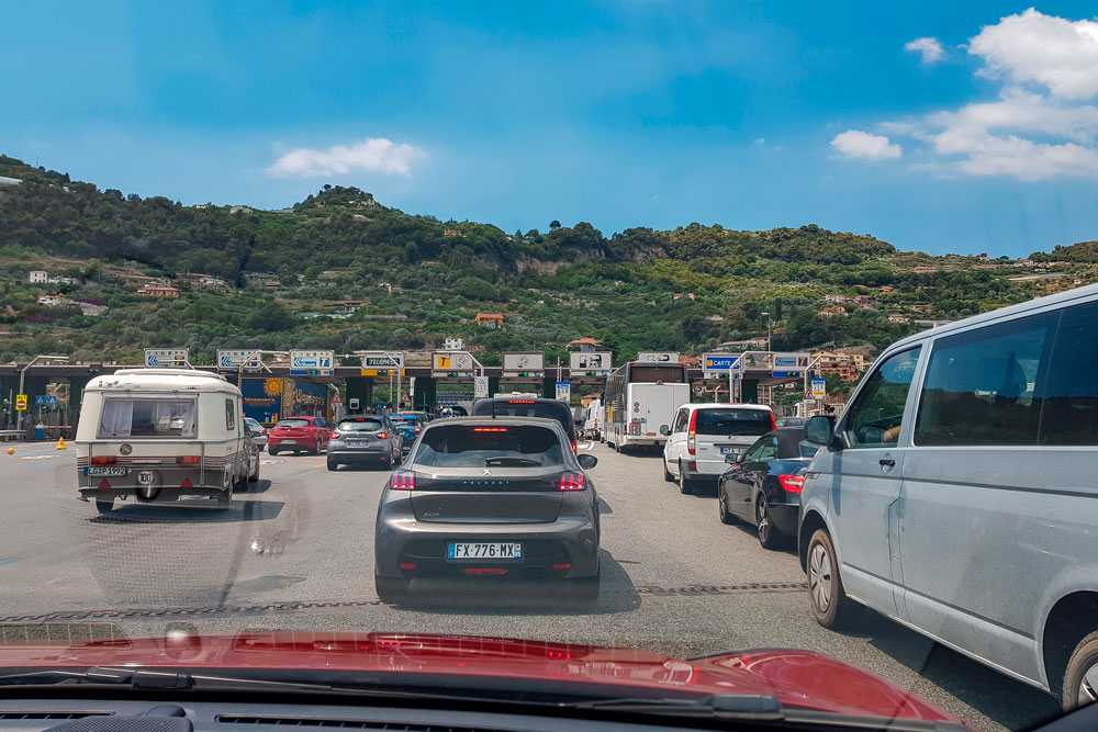 Cars are queued to pay motorway toll fees.
