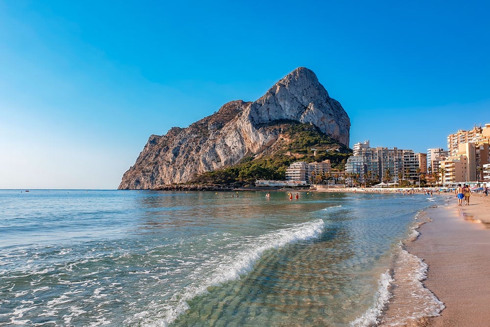 Sandy de la Fossa beach in Calpe with a Calpe rock in the background.