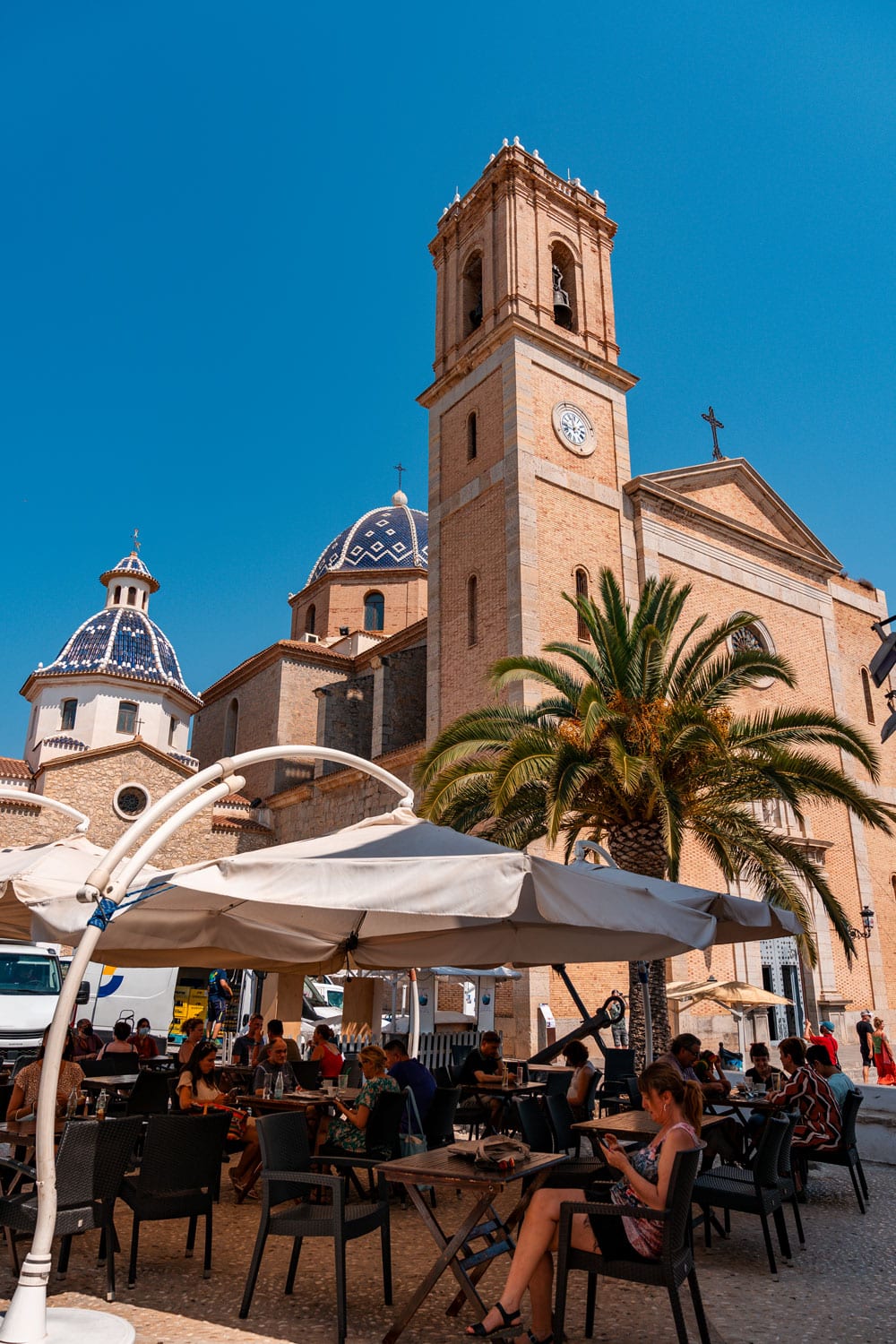 Street cafe in Altea with church in background.