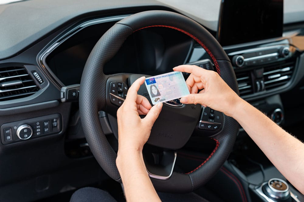 Women holds European driving license.