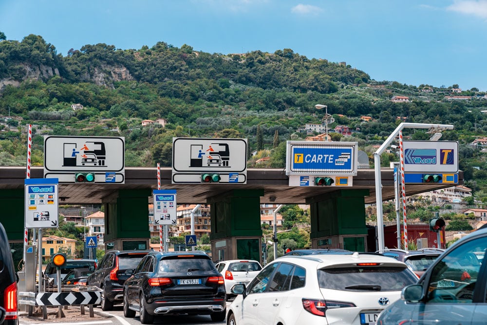 Cars queuing before toll booths.