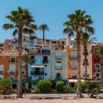 Beautiful Spanish town Villajoyosa with colorful houses and palm trees.