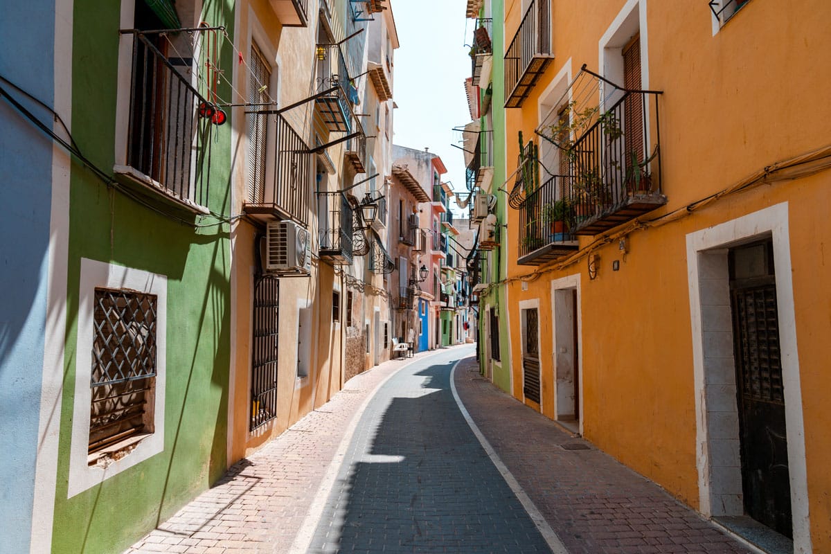 Narrow street in the old town of Villajoyosa with colorful houses.
