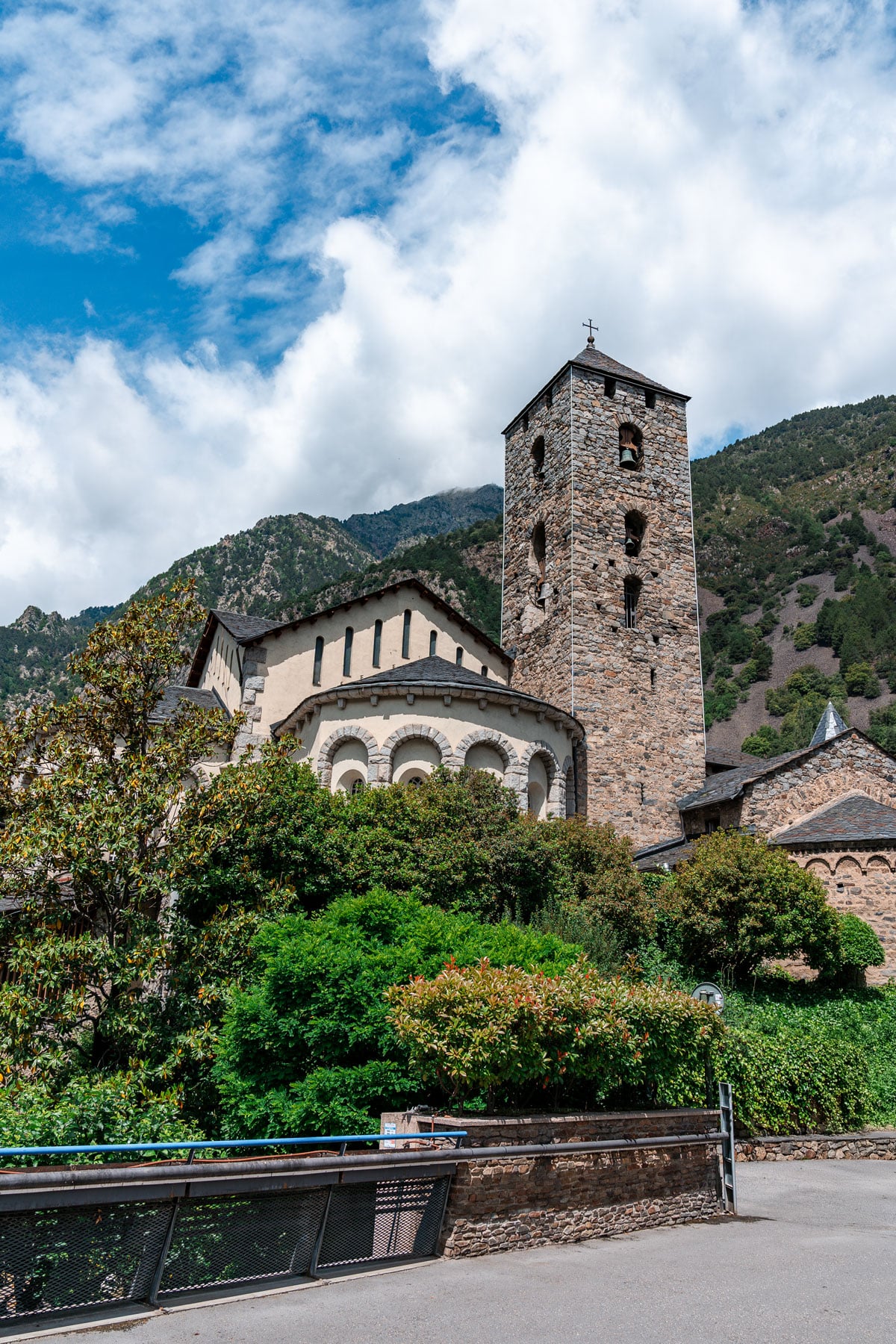 Romanesque Church of Sant Esteve with its stone bell tower rising above the trees.