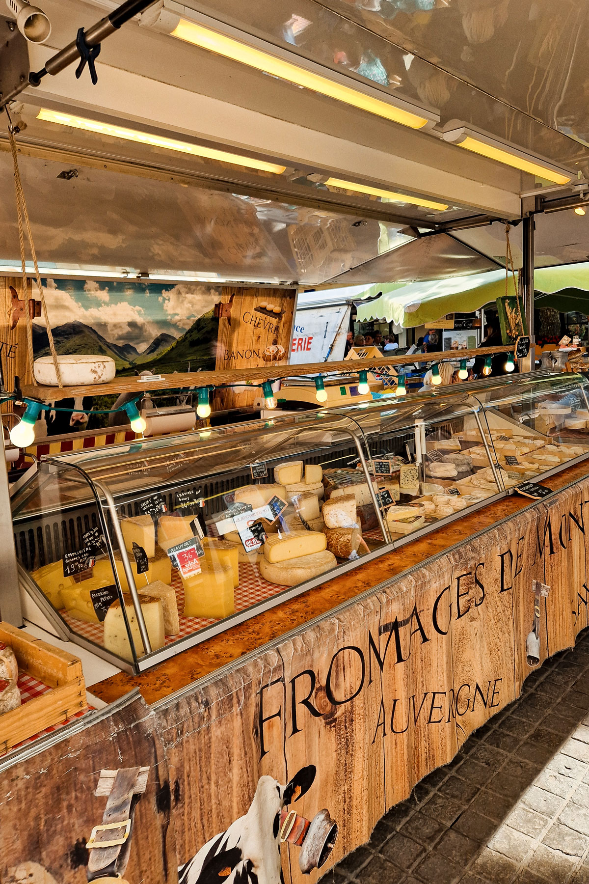 Food stall with cheese and local products at the Thursday market in Orange, France.