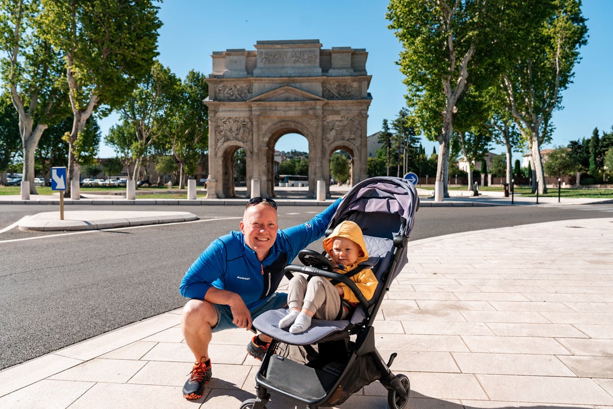 Visiting the Triumphal Arch in Orange, France with a toddler in a stroller.